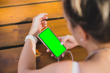 Mockup of a woman using her smartphone on a wood table