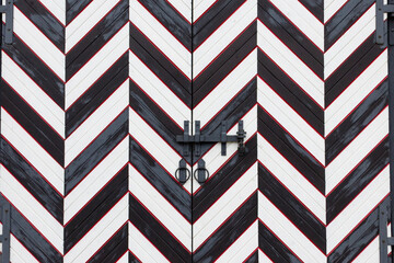 The gate is painted with alternating black and white stripes.