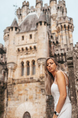 Fototapeta na wymiar Young woman in front of a medieval castle