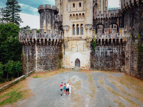 Group of friends in front of the Butron Castle in Vizcaya, Spain