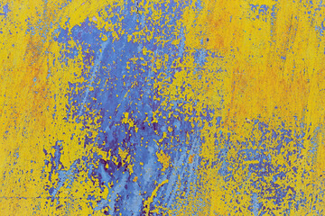 view of a patch of rusty iron with stains of old cracked yellow paint