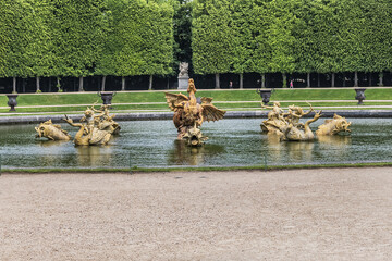 Detail of Dragon Fountain in Versailles palace - royal chateau, 20 km southwest of center of Paris. Versailles, France.