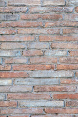 old brick wall of bricks of different sizes as background