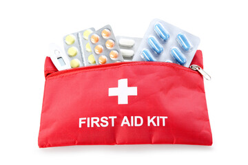 First aid kit with pills in blisters and thermometer isolated on white background