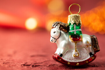 Christmas tree decoration. Decorative horse. Christmas banner on a red background.