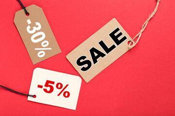 Sale tags with word Sale, 5 and 30 percents on red background