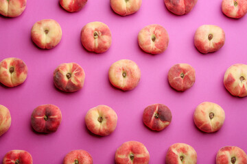 Fresh donut peaches on pink background, flat lay