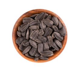 Sunflower seeds isolated on white background. Pile of fried sunflower seeds in wooden bowl. Top view.