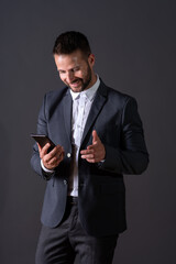A smiling businessman using his smartphone
