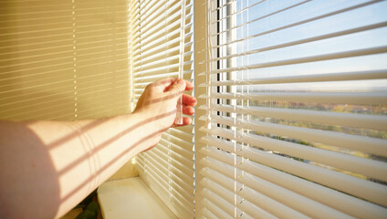 Opening the blinds on the window