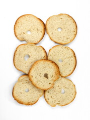 Round bread slices. Bake rolls. Mini bread chips isolated on white background. Round bread slices.