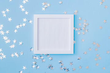 Mockup white frame with christmas decorationon a blue background