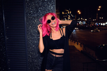 Young girl with sunglasses at night.