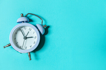Simply minimal design ringing twin bell vintage classic alarm clock Isolated on blue pastel...