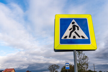 Pedestrian crossing sing and blue cloudy sky