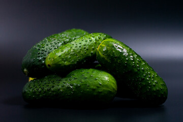 In the center of the screen, a closeup image shows a pile of fresh green cucumbers.