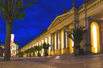 Obraz premium Watercolor drawing of The Mill Colonnade Mlynska kolonada building with columns and hot springs in spa town Karlovy Vary Karlsbad historical centre, night evening view, West Bohemia, Czech Republic