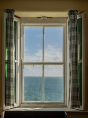 Sea View Out an Old Irish Window, with Shutters and Curtains