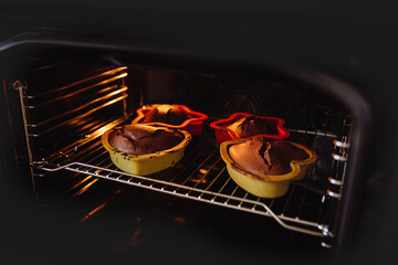 Chocolate cookies in baking tins are cooked in the oven