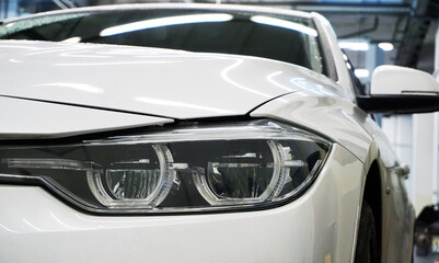 Fototapeta na wymiar Headlight of a new luxury car close-up.
