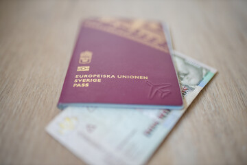 Two Thousand Pesos on a Colombian Bill Partially Inside a Sweden Passport