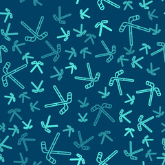 Green line Ice hockey sticks icon isolated seamless pattern on blue background. Vector.