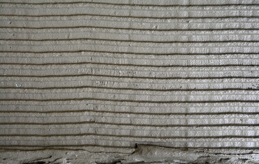 Fresh concrete tehture. Wet mortar surface. Lined grey concrete as background, top view. Tile installation