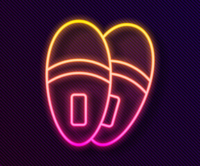 Glowing neon line Slippers icon isolated on black background. Flip flops sign. Vector.