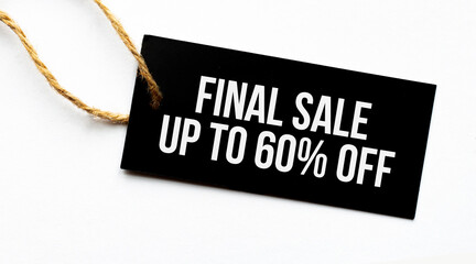 FINAL SALE UP TO 60 percents text on a black tag on a white paper background