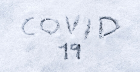 Covid 19 written in the snow. Covid 19 text written in the snow. Concept of covid-19 pandemic in winter and christmas 2020.