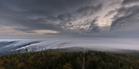 Fototapeta premium Moving clouds and autumn fog over the Black Forest