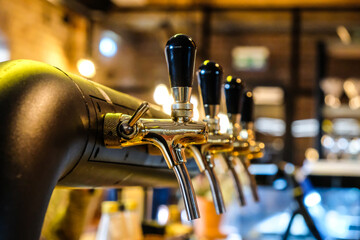 Beer taps at the bar in a row, selective focus