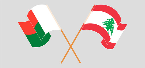 Crossed and waving flags of Madagascar and Lebanon