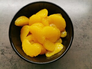 bowl of mandarines - very tasty looking orange fruits in a black bowl - fruitpower - vitamin bomb