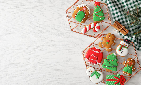 Flat lay composition with delicious homemade Christmas cookies on white table. Space for text