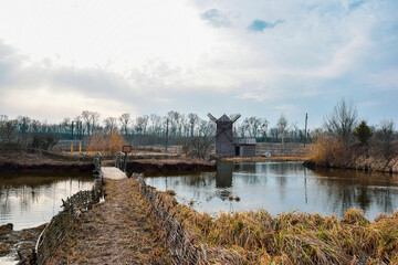 Photo of ethnic villages with a bridge and a wooden mill