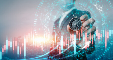 Businessman holding a navigation compass in hand with background a growing virtual hologram stock....