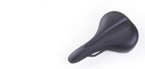 Bicycle saddle on white background, top view close up