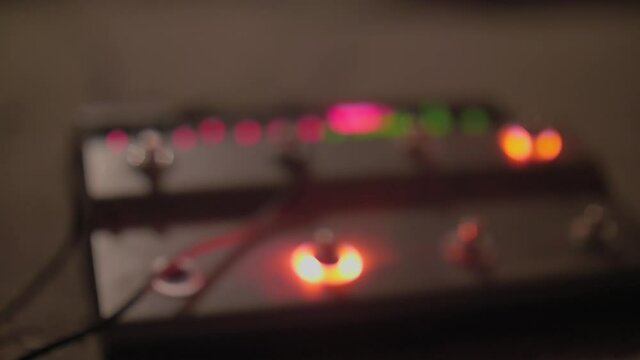 Light twinks on black body of musical equipment. Preparation for concert.