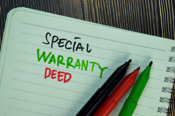 Special Warranty Deed write on a book isolated on Wooden Table.