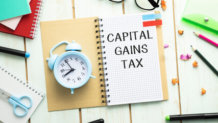 Capital gains tax-text label in the form of a document Registrar planning folder. Mandatory...