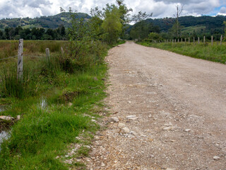 Fototapeta na wymiar Unpaved country road at the central Andean mountains of Colombia, near the colonial town of Villa de Leyva, department of Boyaca.