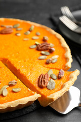 Delicious homemade pumpkin pie on black table, closeup