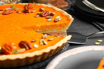 Delicious homemade pumpkin pie on black table, closeup