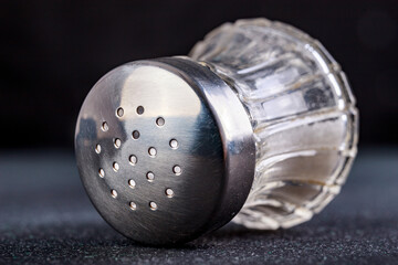 Glass salt shaker with metal cap, Kitchen accessories for seasoning dishes.