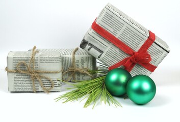 Gifts wrapped in old newspaper on white background
