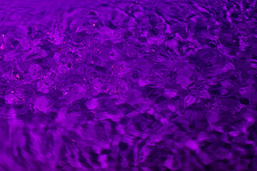 splash of water in lilac light. Abstract wallpaper