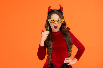 shouting emotionally child in imp horn costume to halloween with funny party glasses, halloween...