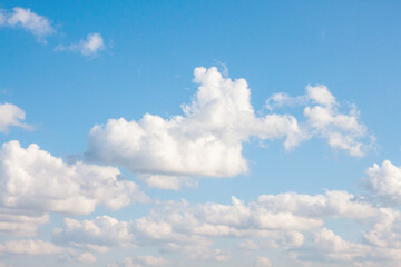 Bright blue sky with light white clouds. The concept of lightness and carelessness