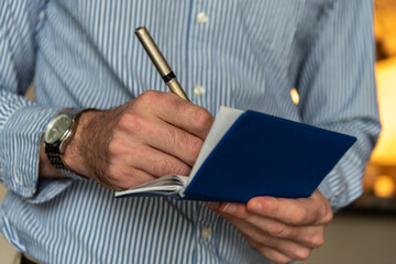Close up of hands writing a personal check.